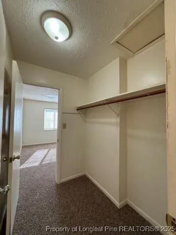 an empty room with a empty space and windows