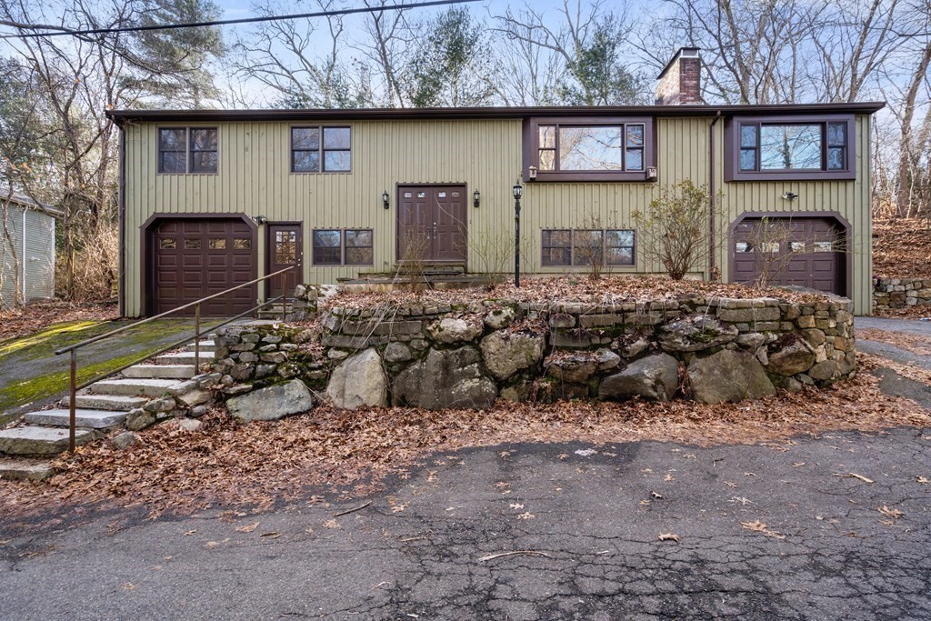 a view of a house with a yard and a wooden fence