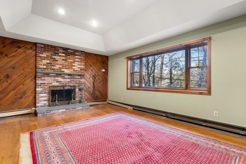18 St Cloud Avenue Needham, MA 02492 - Photo 3 of 25 a view of an empty room with a fireplace and a window