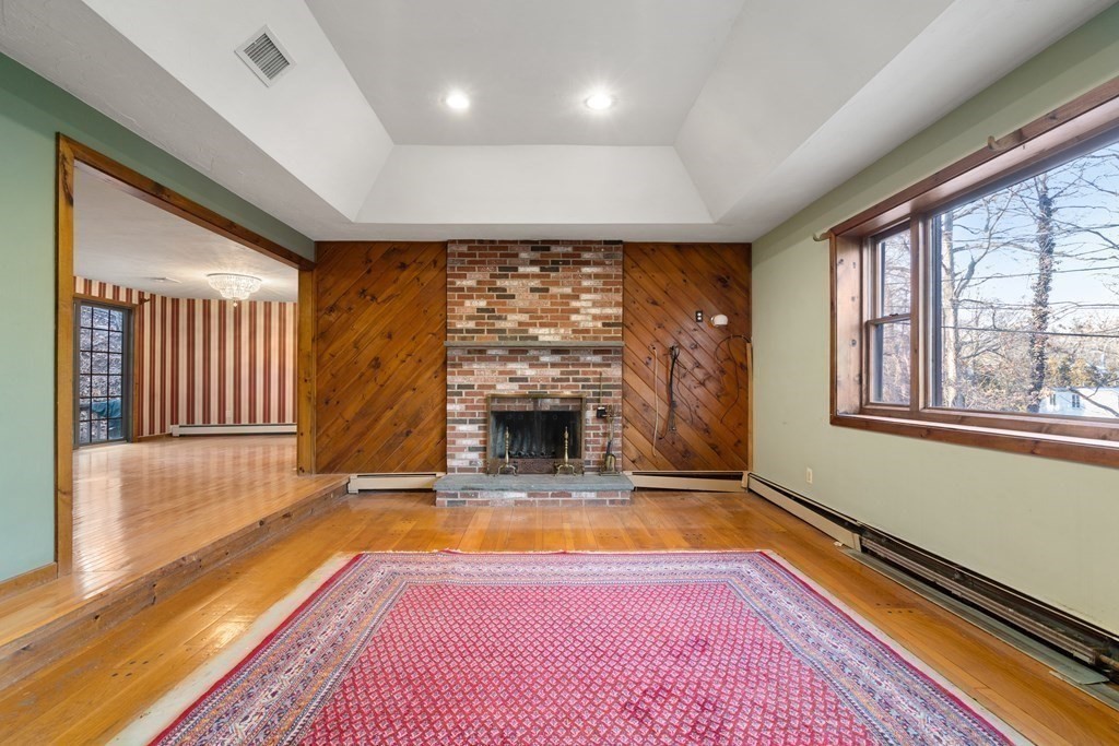 18 St Cloud Avenue Needham, MA 02492 - Photo 9 of 25 a view of a livingroom with a fireplace window and wooden floor