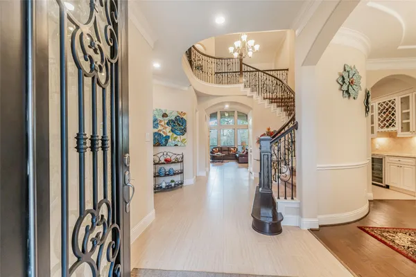 a kitchen with stainless steel appliances kitchen island granite countertop a refrigerator a stove a sink a dining table and chairs with wooden floor