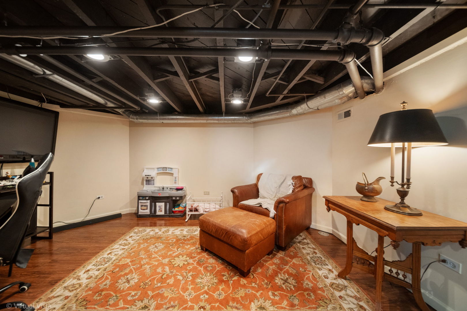253 Olmsted Road Riverside, IL 60546 - Photo 29 of 36 a living room with furniture and a flat screen tv