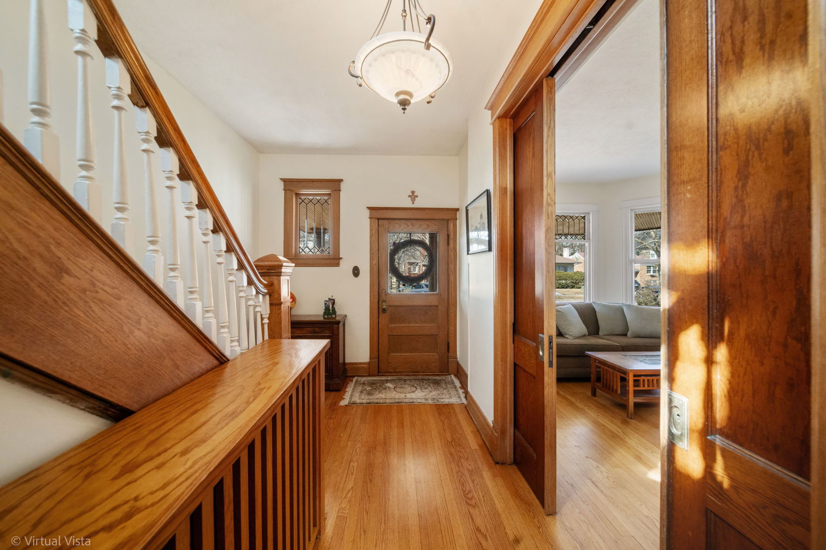 253 Olmsted Road Riverside, IL 60546 - Photo 8 of 36 a hallway with wooden floor chandelier and livingroom