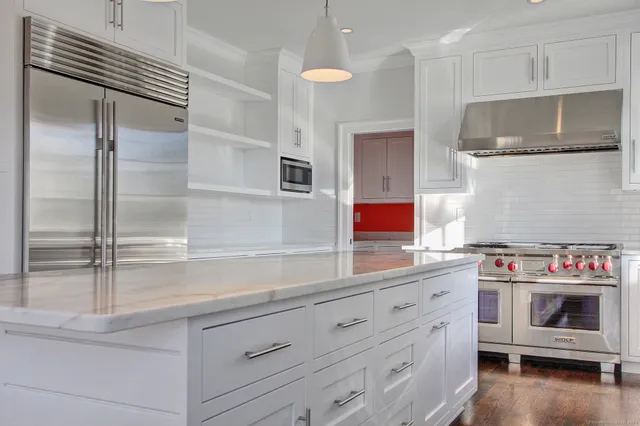 a kitchen with a refrigerator and a stove