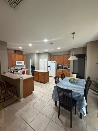 a dining room with a wooden table and chairs