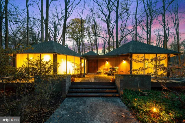 a backyard of a house with barbeque oven table and chairs