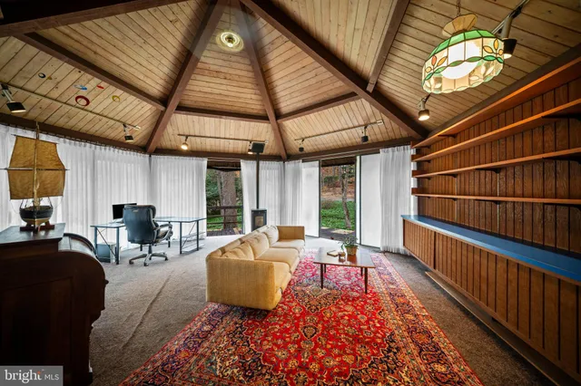 a view of front door and bedroom with furniture