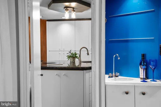 a kitchen with kitchen island a sink stainless steel appliances and cabinets