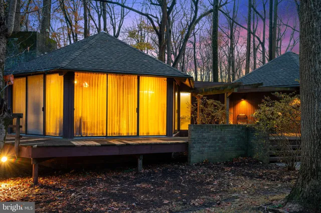 a bedroom with a bed and large window