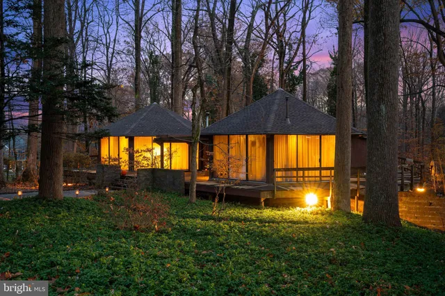 a view of a chairs and an umbrella in front of house