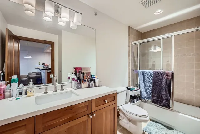 a bathroom with a toilet a sink and mirror