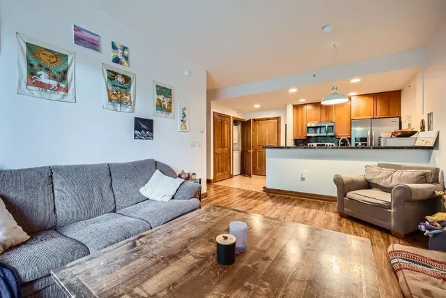 a living room with furniture and kitchen view