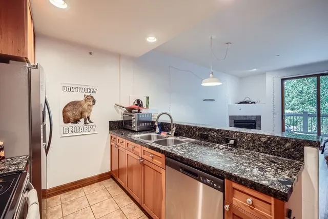 a kitchen with a sink stove and refrigerator