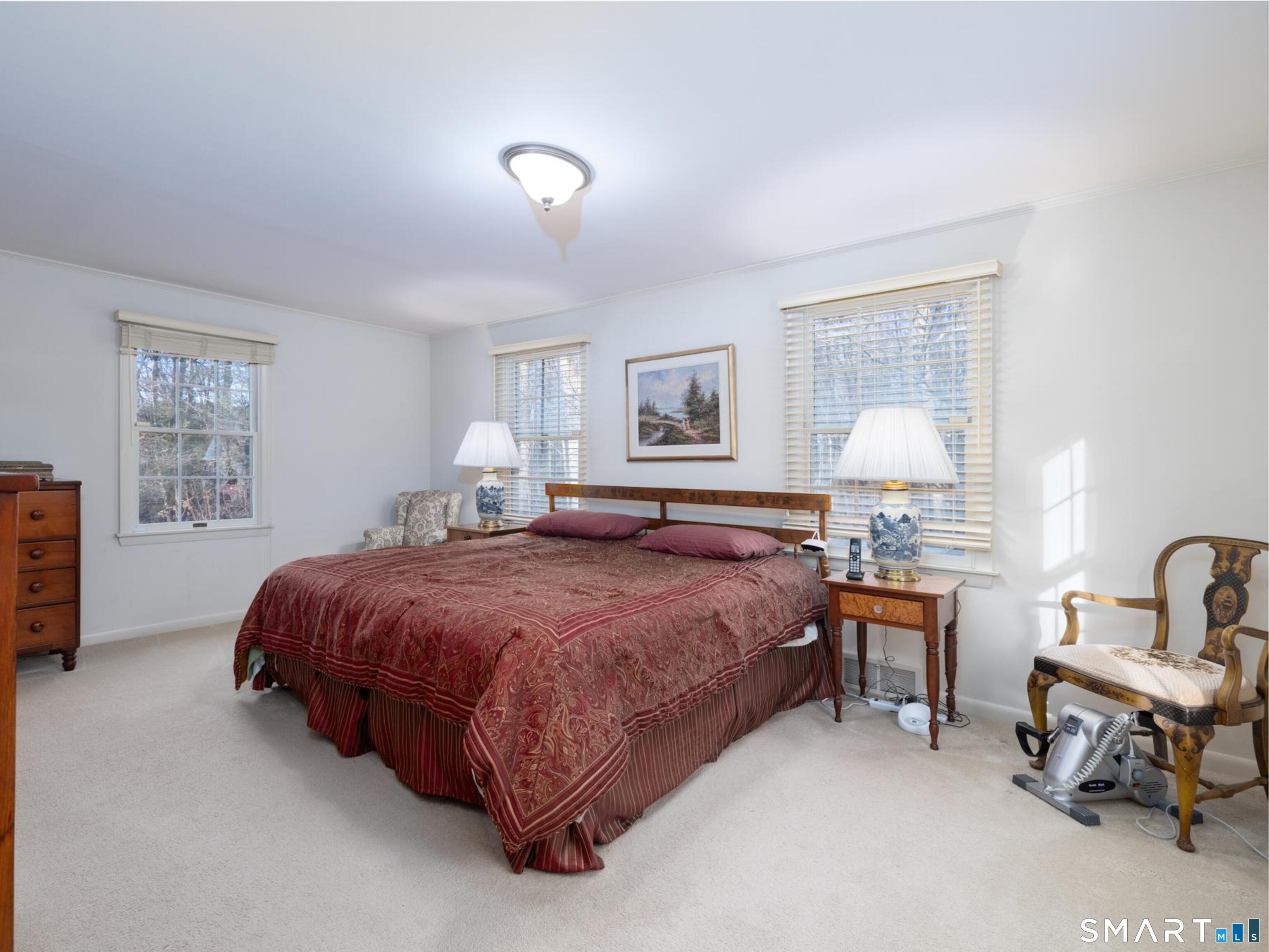 117 Crest Road Middlebury, CT 06762 - Photo 20 of 38 Expansive primary bedroom on the main level has twin closets and a full bath with a walk in shower and a tub.
