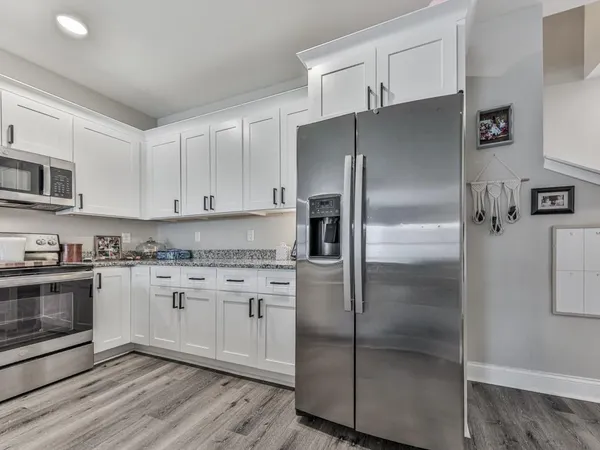 a kitchen with stainless steel appliances cabinets a refrigerator and a stove