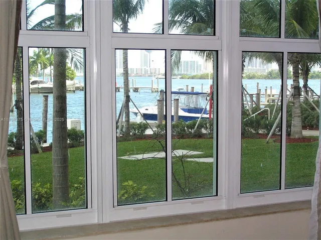 a view of a tall building with a tree and a yard