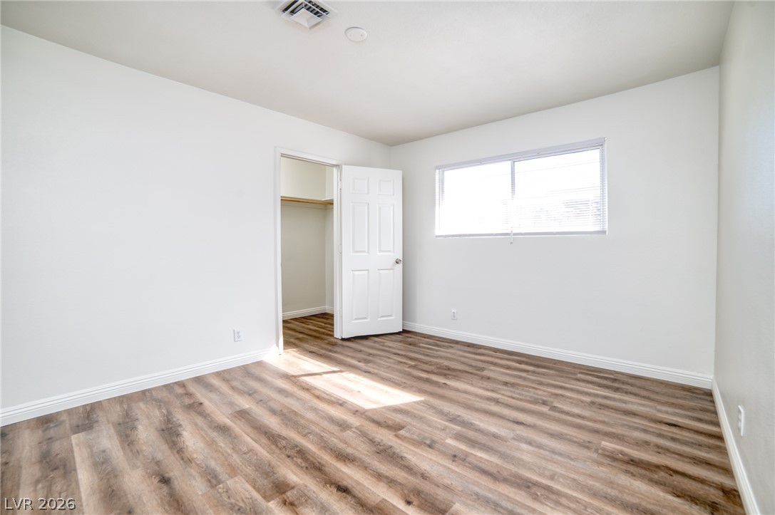 3556 Ruth Drive Las Vegas, NV 89121 - Photo 13 of 21 Natural light illuminates the rich hardwood-style flooring in this spacious, tranquil bedroom.