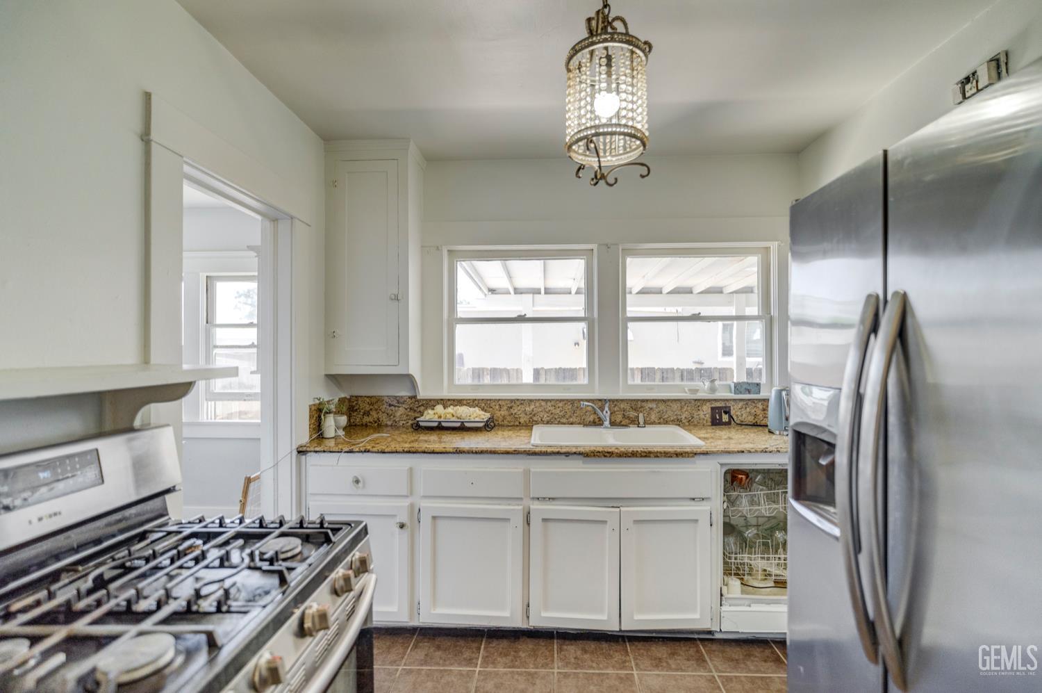 Undisclosed Address Bakersfield, CA 93304 - Photo 13 of 30 a kitchen with stainless steel appliances granite countertop a sink stove and refrigerator