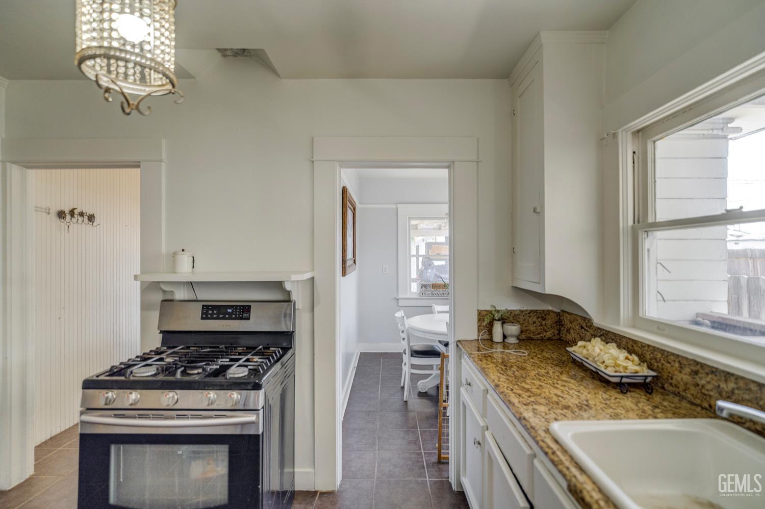 Undisclosed Address Bakersfield, CA 93304 - Photo 16 of 30 a kitchen with a stove and cabinets