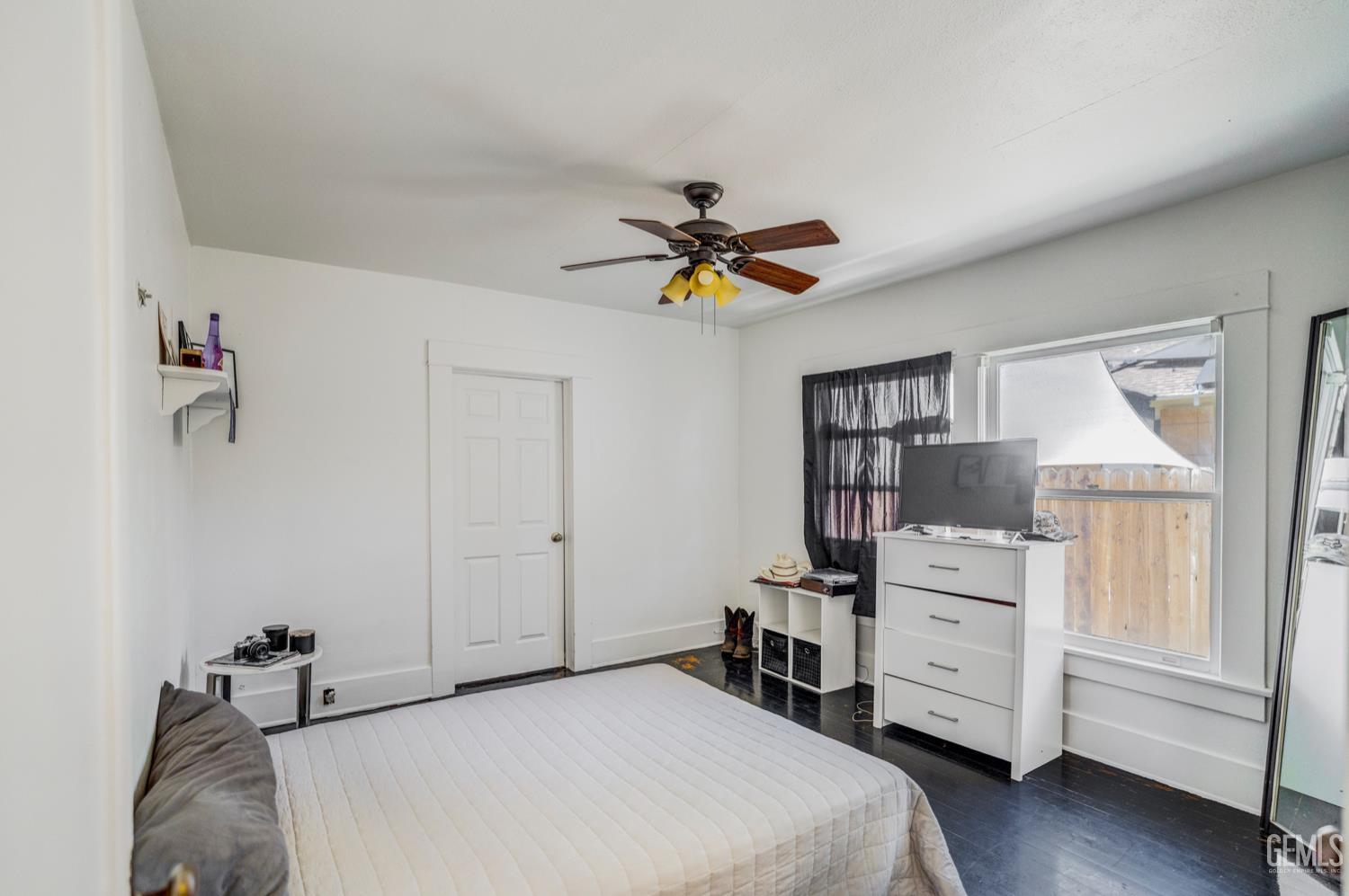Undisclosed Address Bakersfield, CA 93304 - Photo 19 of 30 a bedroom that has a bed and a chandelier