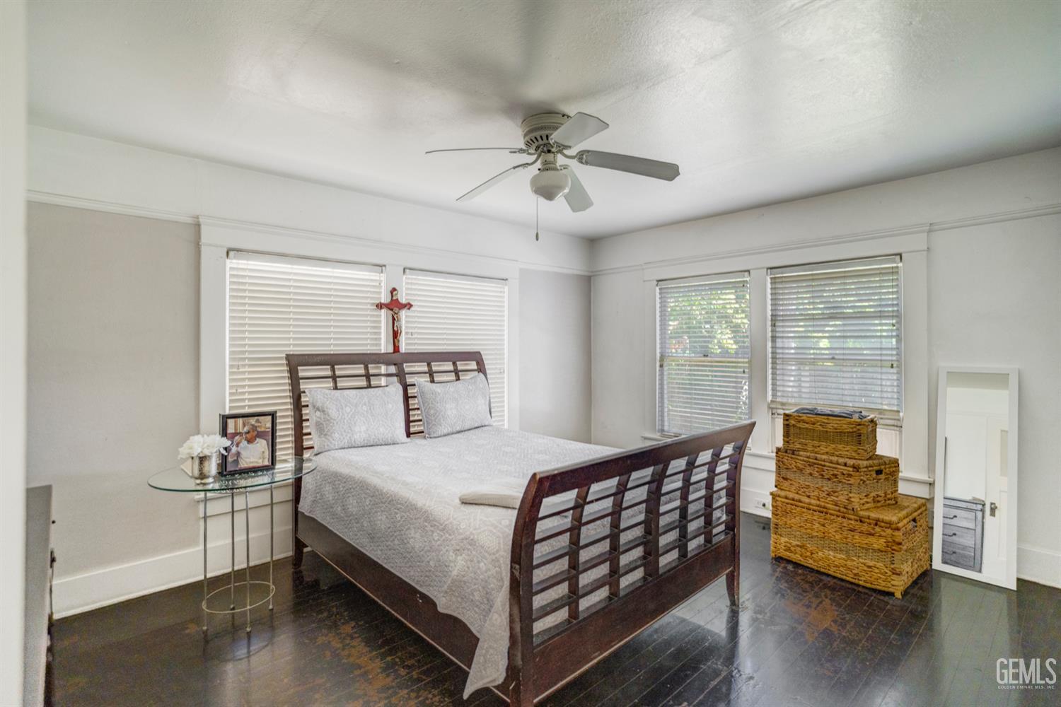 Undisclosed Address Bakersfield, CA 93304 - Photo 20 of 30 a bedroom with a bed and wooden floor