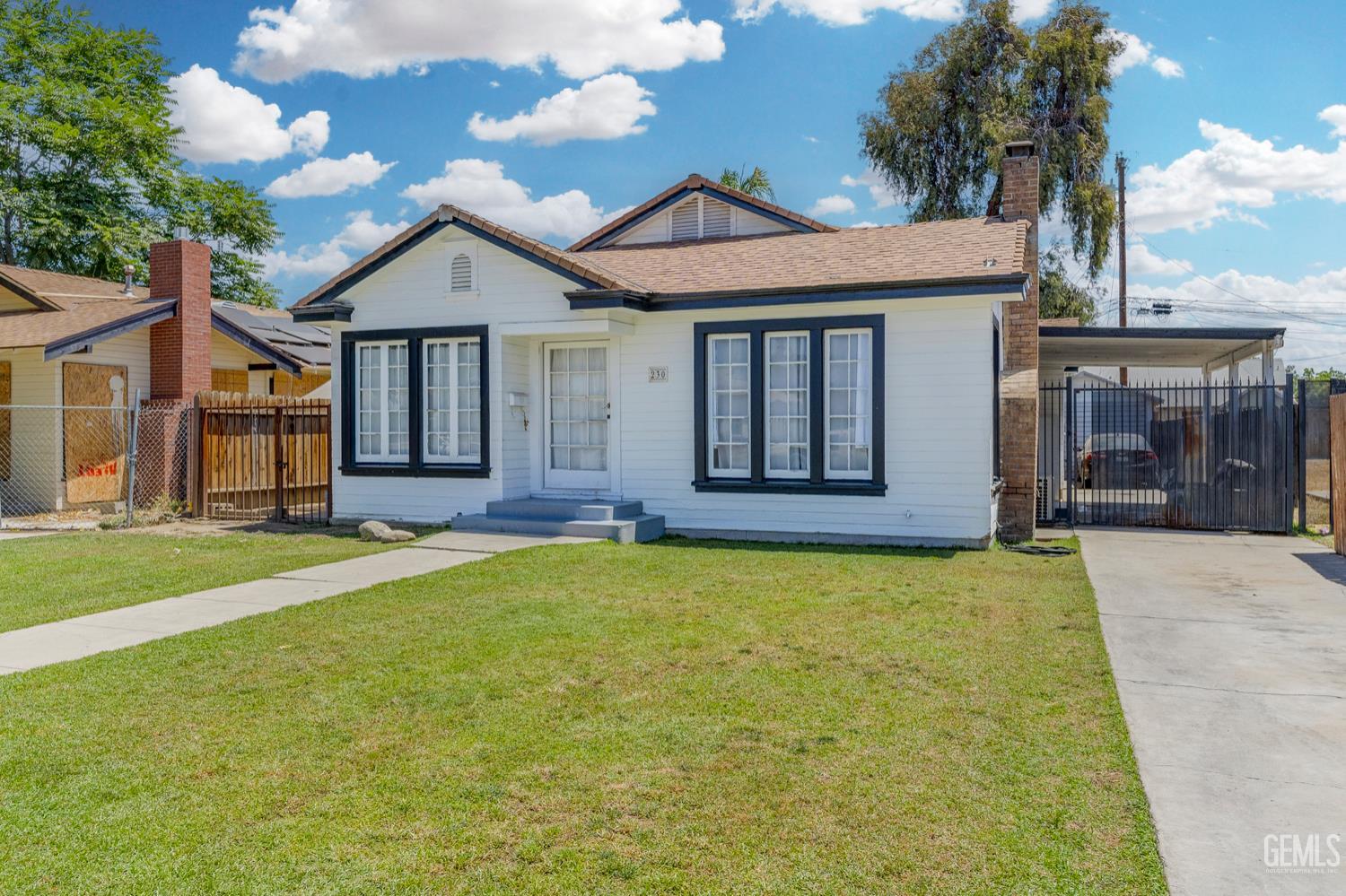 Undisclosed Address Bakersfield, CA 93304 - Photo 2 of 30 a front view of a house with a garden