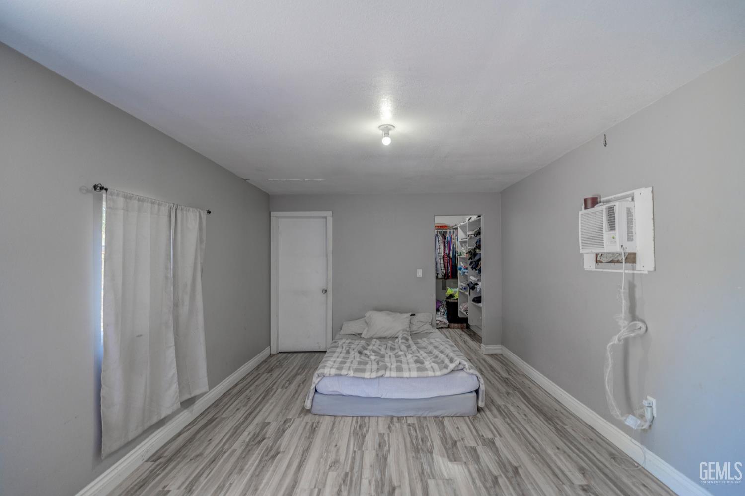 Undisclosed Address Bakersfield, CA 93304 - Photo 25 of 30 a view of a bedroom with wooden floor and closet