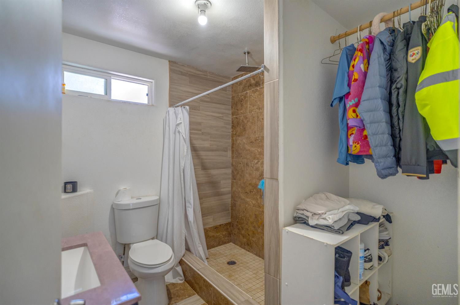 Undisclosed Address Bakersfield, CA 93304 - Photo 26 of 30 a bathroom with a toilet sink and shower