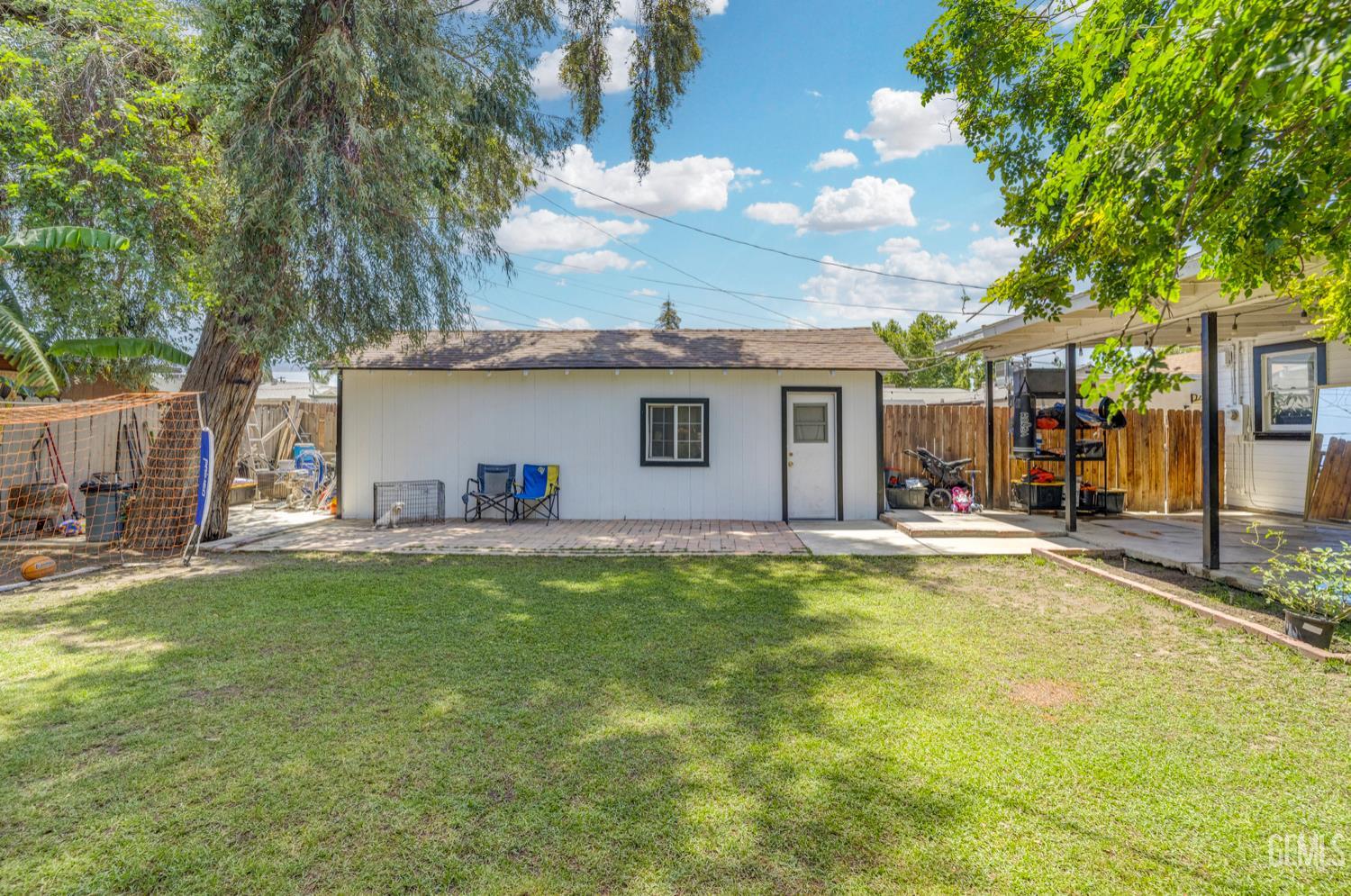 Undisclosed Address Bakersfield, CA 93304 - Photo 29 of 30 a view of a house with a swimming pool and a yard