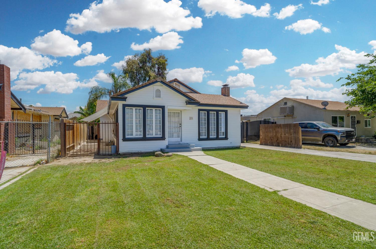 Undisclosed Address Bakersfield, CA 93304 - Photo 3 of 30 a front view of a house with garden