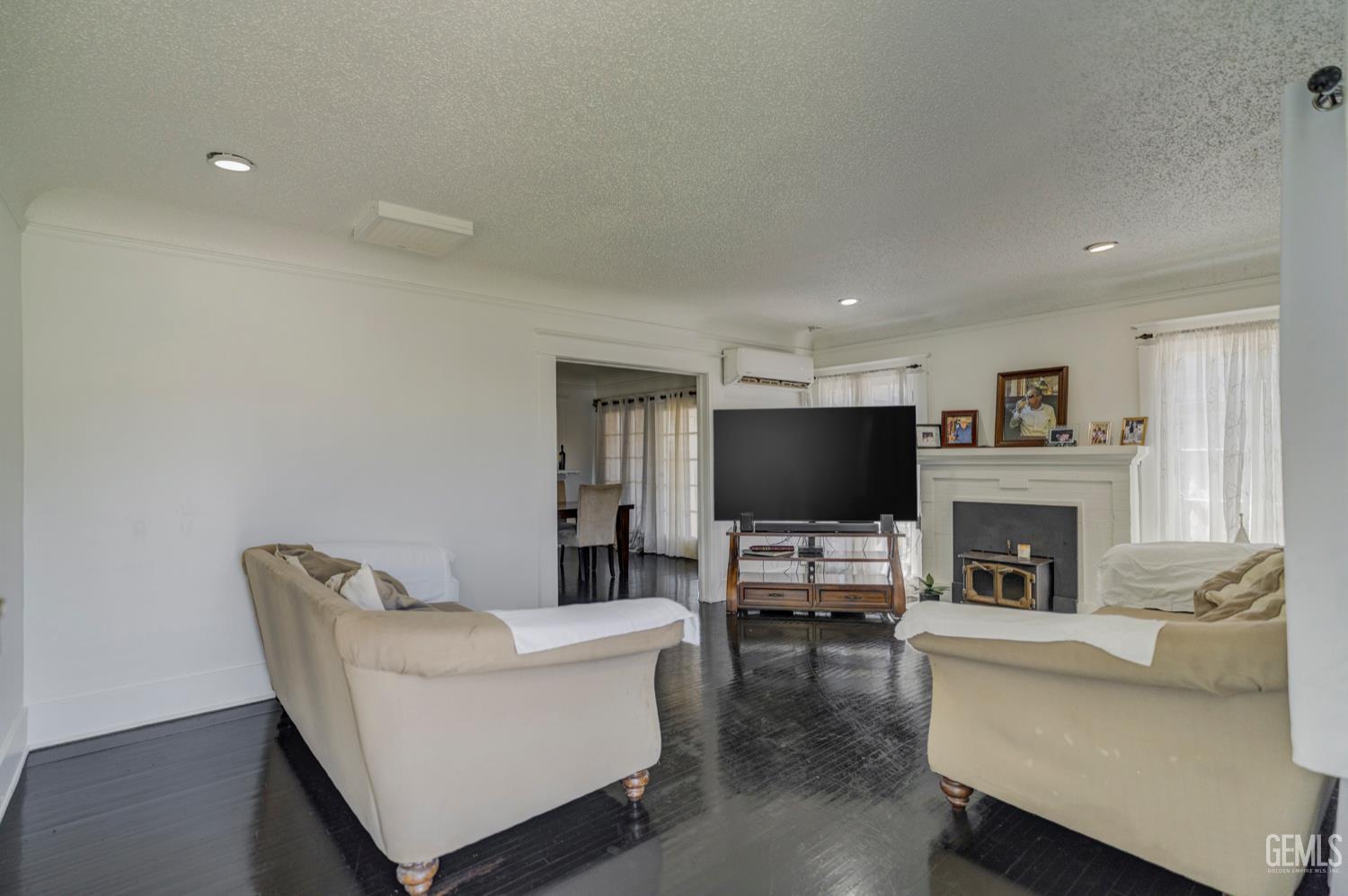 Undisclosed Address Bakersfield, CA 93304 - Photo 4 of 30 a living room with furniture and a flat screen tv