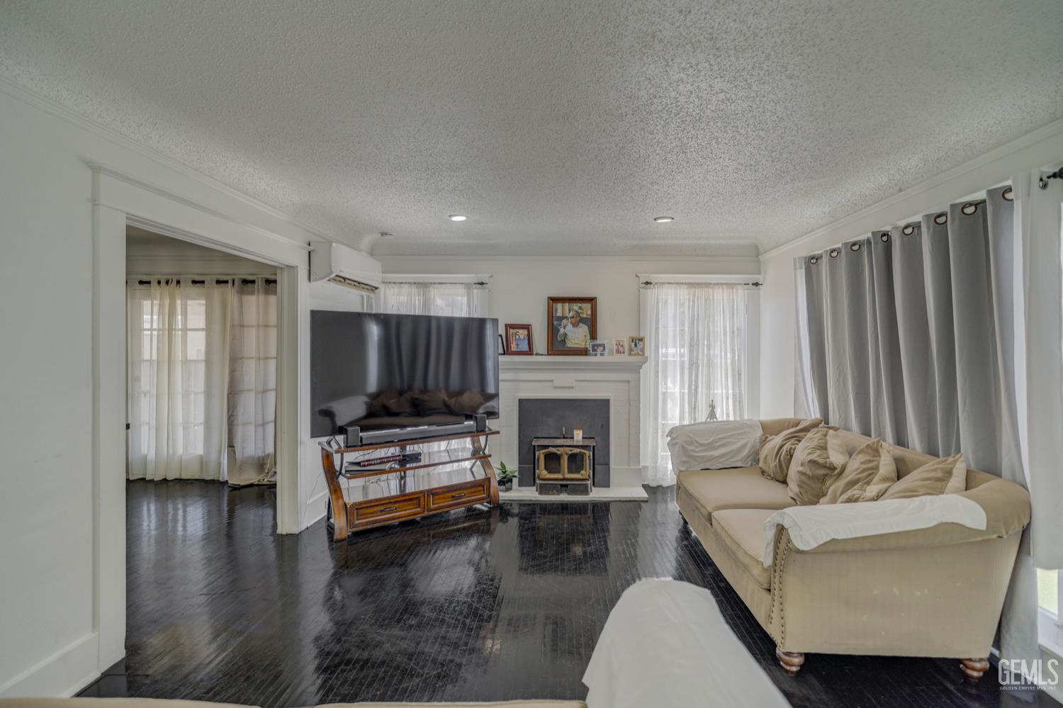 Undisclosed Address Bakersfield, CA 93304 - Photo 5 of 30 a living room with furniture and a fireplace