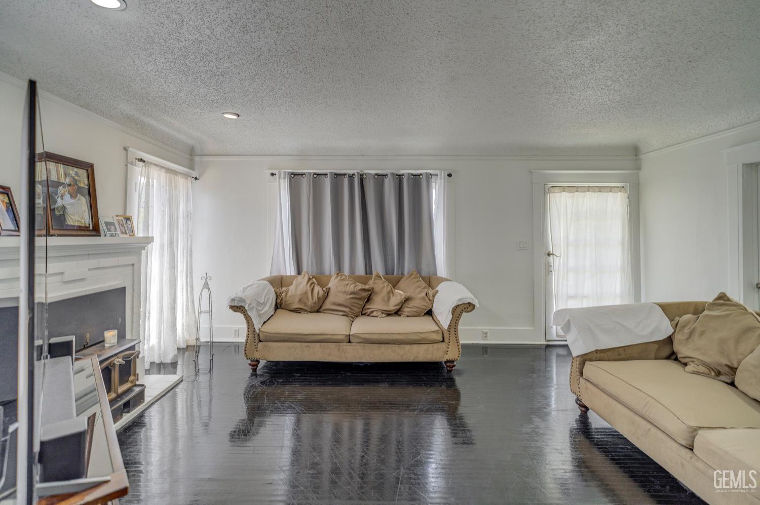 Undisclosed Address Bakersfield, CA 93304 - Photo 7 of 30 a living room with furniture and a fireplace