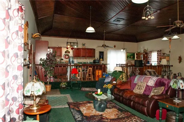 a living room filled with lots of furniture and a chandelier