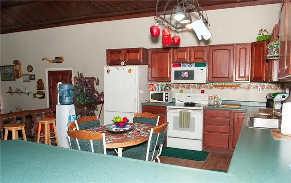 a kitchen with a refrigerator and a stove top oven