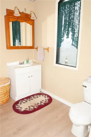 a bathroom with a toilet sink and mirror