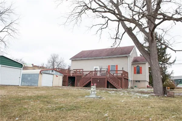 a view of a house with a yard covered in snow