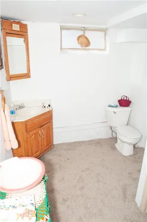 a bathroom with a toilet a sink and a mirror