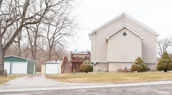 a view of a house with a yard covered in snow