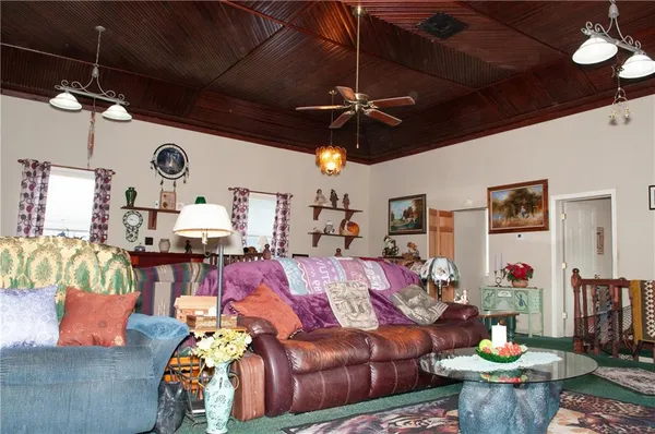 a living room with furniture and a chandelier