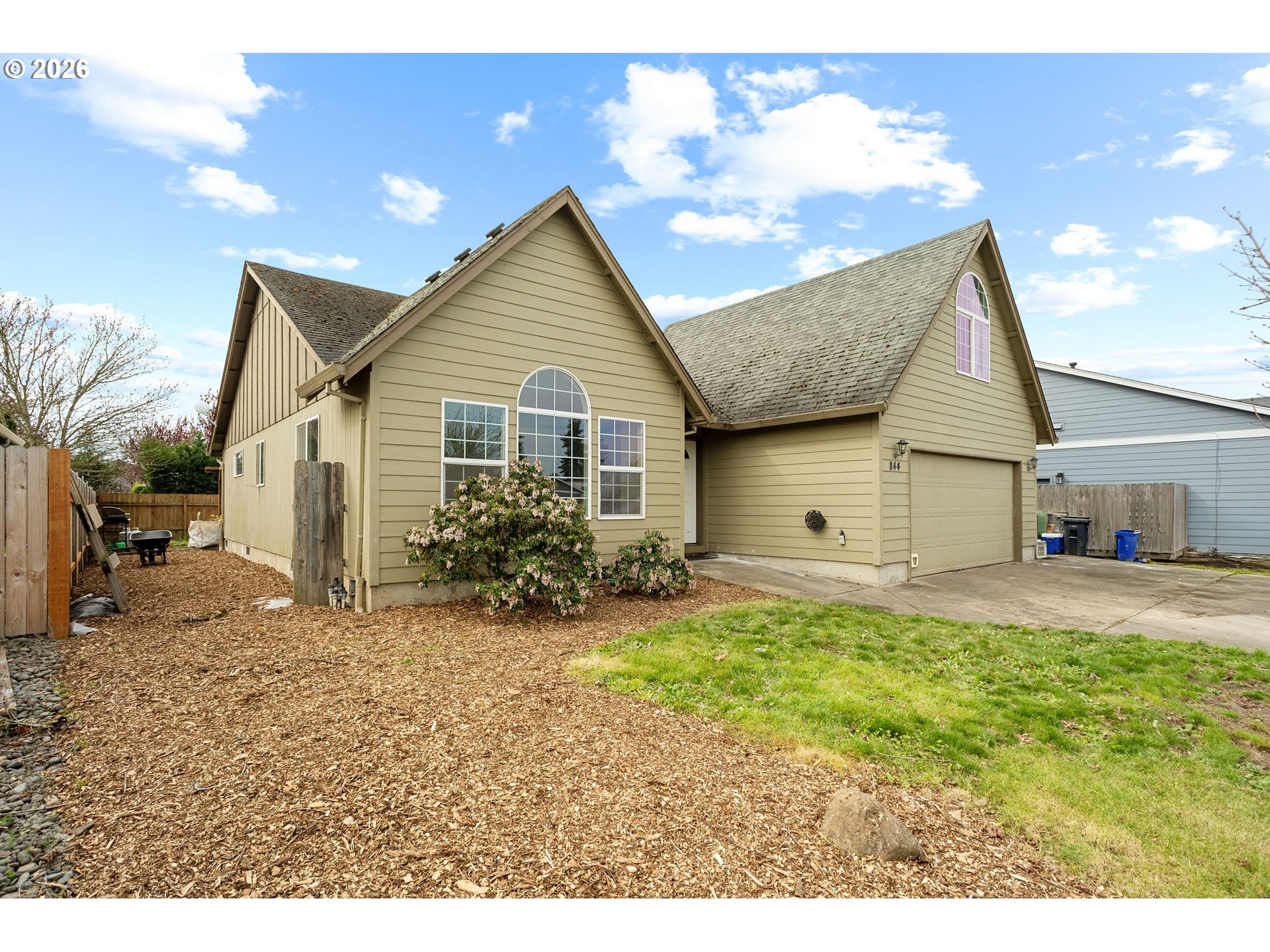 a view of a house with a yard and garage