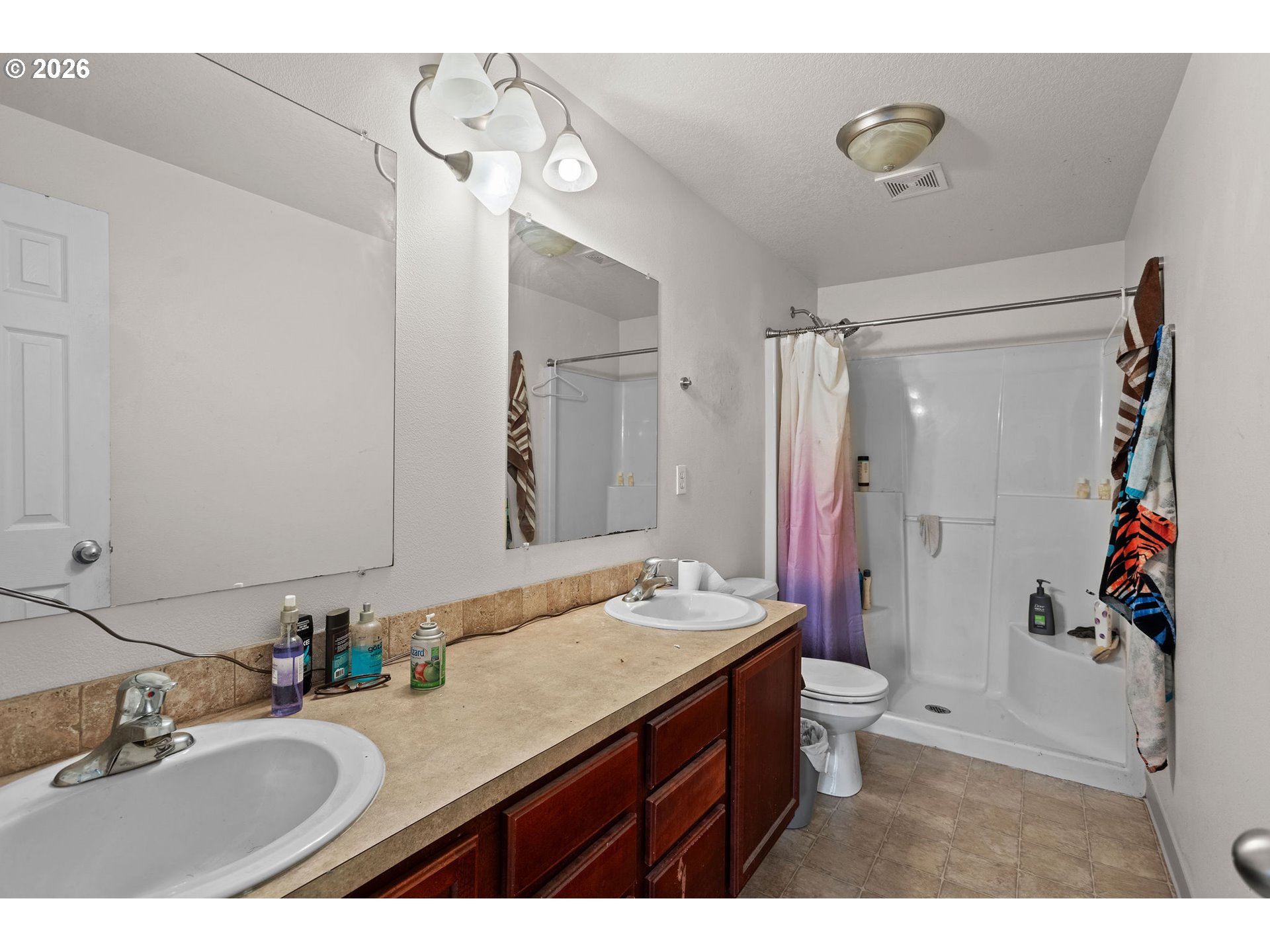 844 Hazel Street Jefferson, OR 97352 - Photo 15 of 22 a bathroom with a granite countertop sink a mirror a vanity and shower
