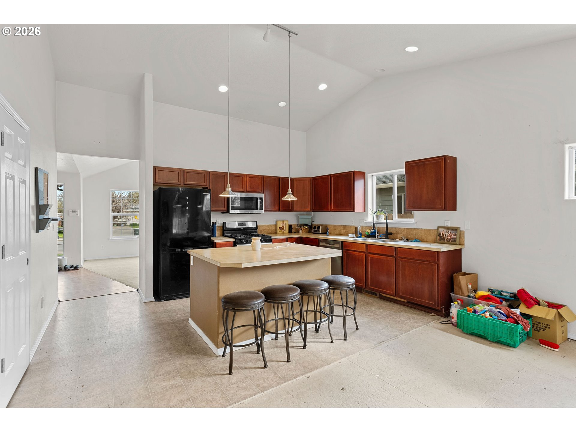 844 Hazel Street Jefferson, OR 97352 - Photo 8 of 22 a open kitchen with stainless steel appliances kitchen island granite countertop a table chairs sink and cabinets