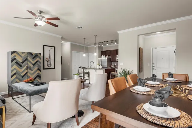 a living room with furniture and a dining table