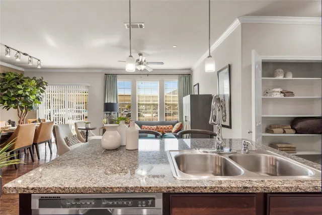 a kitchen with granite countertop a sink and a refrigerator