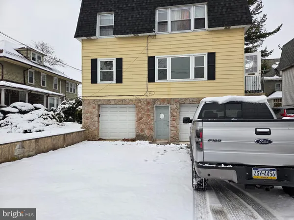 a front view of a house with parking space