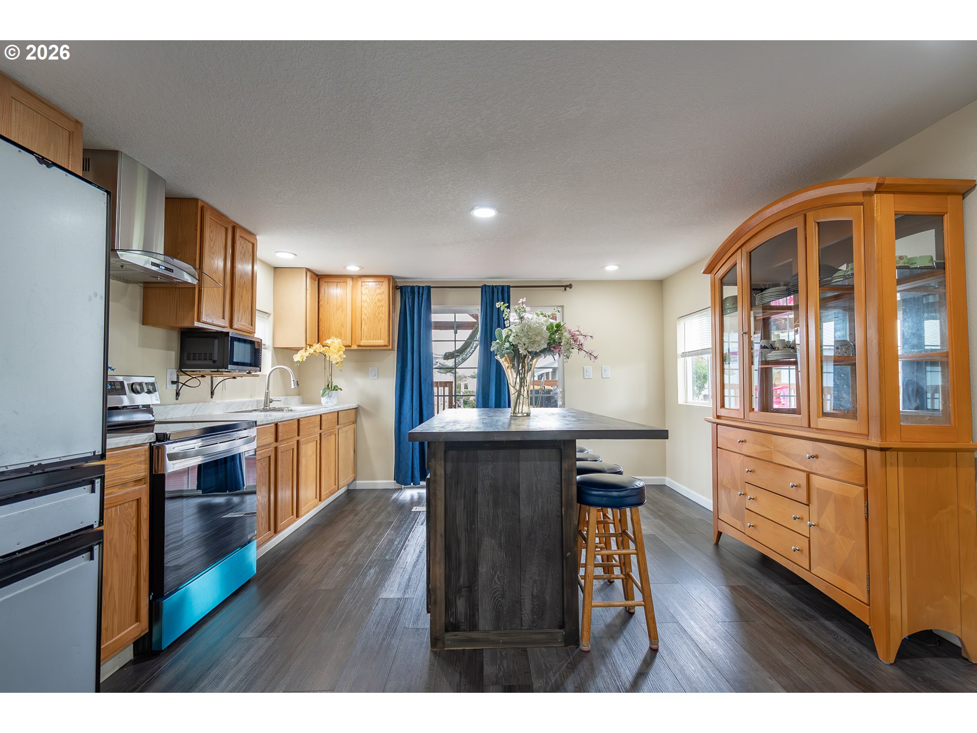 3516 Turner Road Southeast Salem, OR 97302 - Photo 18 of 35 a open kitchen with stainless steel appliances granite countertop a refrigerator a stove top oven with wooden floors