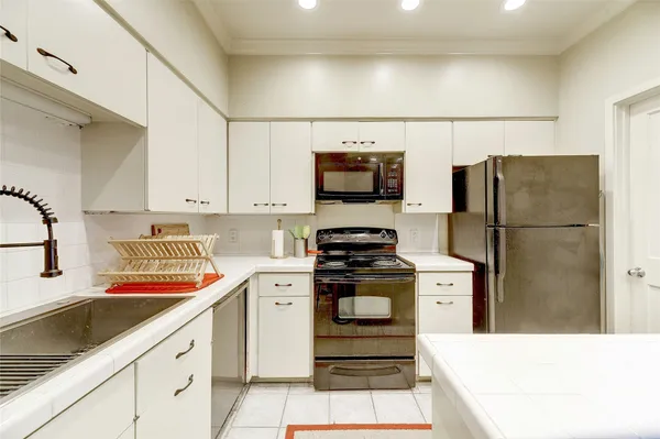 a kitchen with stainless steel appliances a refrigerator sink and stove