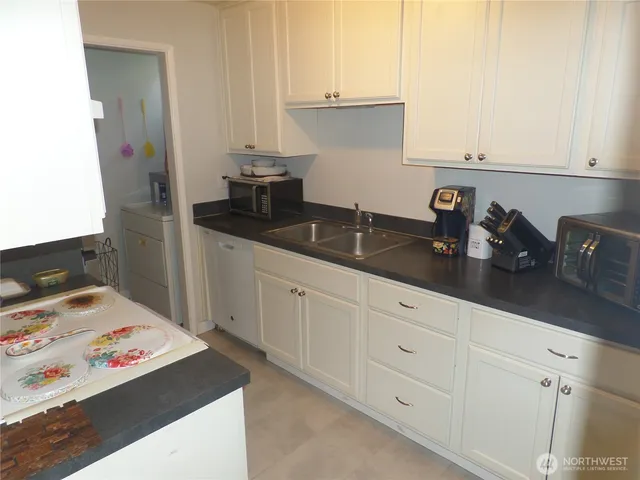 a kitchen with a refrigerator and a sink