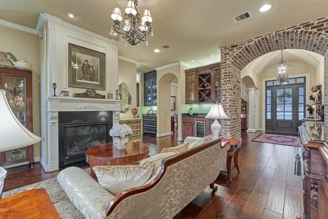 a living room with furniture ceiling fan and a wooden floor
